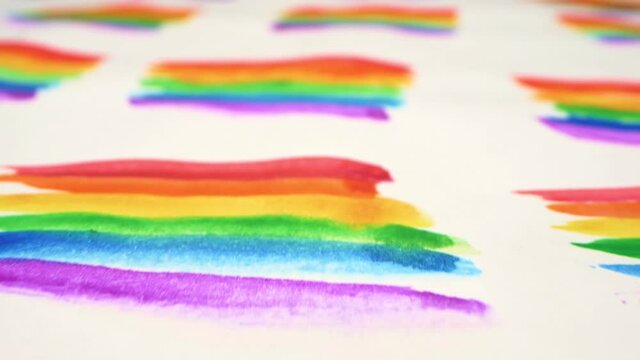 backdrop. extremely close-up, detailed. background of rainbows painted with watercolor on a sheet of paper.