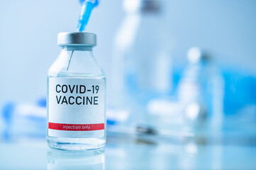 A single bottle vial of Covid-19 vaccine. Medical concept vaccination hypodermic injection...