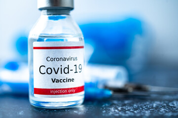 A single bottle vial of Covid-19 vaccine. Medical concept vaccination hypodermic injection...