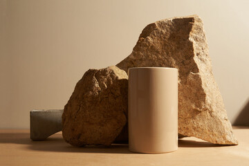 Beige stone and a piece of gray podium tile on a beige background, natural background for your...