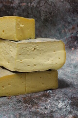 yellow, plump quinces, arranged on the counter, quince fruit and long-maturing cheeses, montasio cheese and asiago cheese, Italian cheeses, healthy food