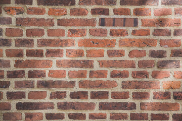 Fototapeta premium Old red brick wall of rough brickwork