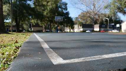 Fototapeta na wymiar Empty basketball court in a park - angle view