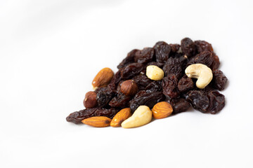 A healthy snack of a mixture of nuts and raisins on a white background
