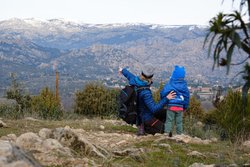 Mom doing a trekking route with her son, teaching him about nature and the mountains.