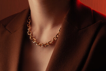 Cropped close up portrait of young woman with perfect silky skin, demonstrating golden jewelry...