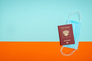 a medical mask is attached to the passport. The concept of travel between countries during the coronavirus outbreak