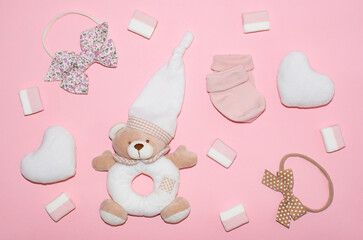 Cute baby girl clothes and accessories, soft white hearts, teddy bear, sweets, bows, socks. Happy Valentine day concept