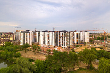 Aerial view of city residential area with high apartment buildings under construction.