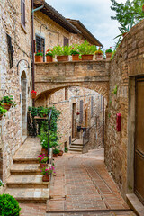 Narrow alleys and ancient medieval buildings in the picturesque town of Spello, in Umbria (Italy)