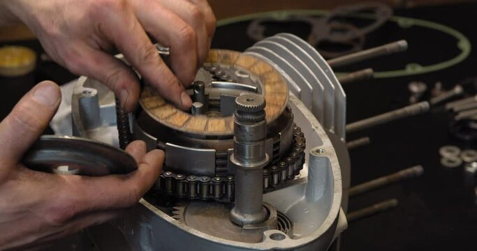 Classic motorcycle restoration engine repair clutch assemble in garage workshop