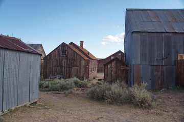 Fototapeta na wymiar Abandoned buildings at the abandoned Bodie ghost town in the Sierra Nevada mountains of California on a sunny day with clouds