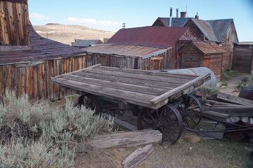 Abandoned buildings at the abandoned Bodie ghost town in the Sierra Nevada mountains of California on a sunny day with clouds