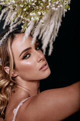 portrait of blonde bride in white dress and bouquet