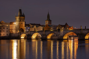 Fototapeta na wymiar .Charles Bridge at night and light from street lights on the Vltava River in the center of Prague at night in the Czech Republic