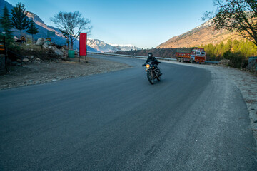 Fototapeta na wymiar Person on bike in Kullu valley , Himachal Pradesh