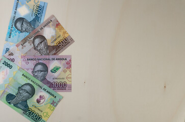 Overhead shot of Angolan Kwanzas banknotes new serie launched at the end of 2020