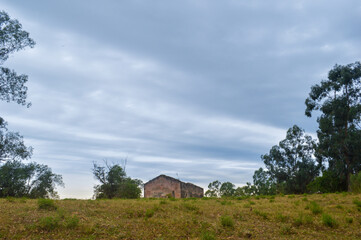 Fototapeta premium Abandoned house in a field far from the city