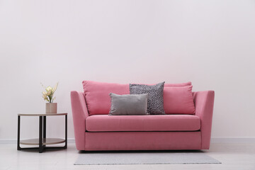 Simple room interior with comfortable pink sofa, space for text