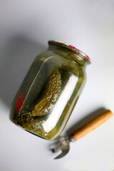 jar of homemade marinated pickles with a bottle opener