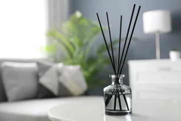 Foto op Canvas Aromatic reed air freshener on white table in room. Space for text © New Africa