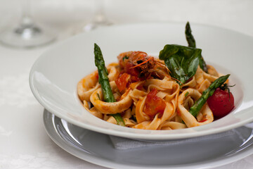 Delicious pasta with seafood , asparagus and cherry tomatoes