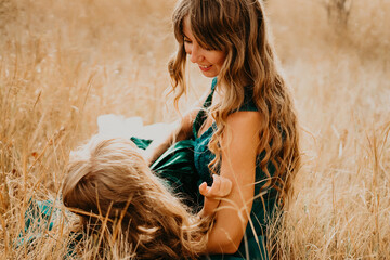 Mom hugs and laughs with her daughter in nature