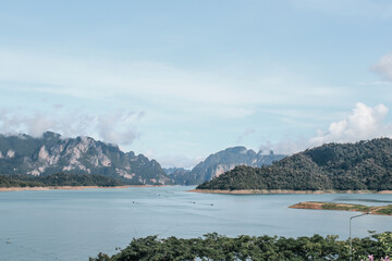 Beautiful mountains lake river sky and natural attractions in Cheow Lan lake, Ratchaprapha Dam, Khao Sok National Park in Thailand in a summer day