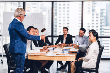 Group of professional business meeting and discussing strategy with new startup project.Creative business people planning and brainstorm with document report in modern workloft.Teamwork concept