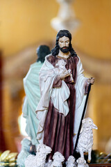 The statue of Jesus is photographed with his back to the mirror.