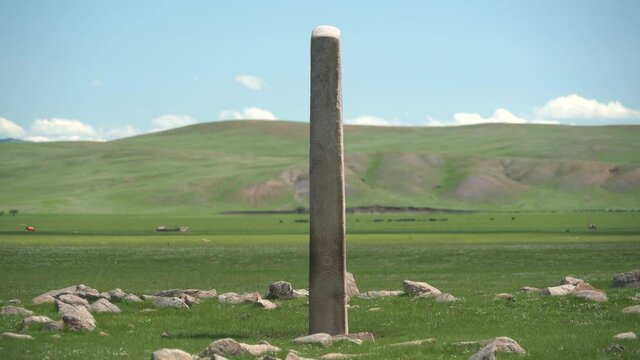 Inscription of obelisk menhir from old ancient times.Deer stone is megalith carved with symbols.Deerstone cemeteries orthostat stele steppe history historical antique petroglyph monuments memorial 4K
