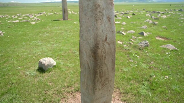 Inscription of obelisk menhir from old ancient times.Deer stone is megalith carved with symbols.Deerstone cemeteries orthostat stele steppe history historical antique petroglyph monuments memorial 4K