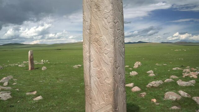 Inscription of obelisk menhir from old ancient times.Deer stone is megalith carved with symbols.Deerstone cemeteries orthostat stele steppe history historical antique petroglyph monuments memorial 4K