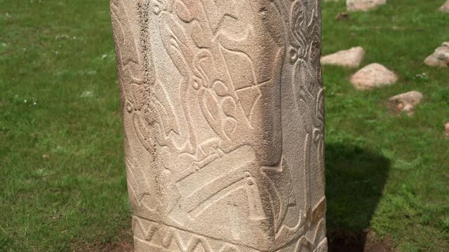 Inscription of obelisk menhir from old ancient times.Deer stone is megalith carved with symbols.Deerstone cemeteries orthostat stele steppe history historical antique petroglyph monuments memorial 4K