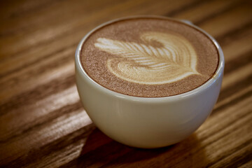 Cup of hot coffee with milk art