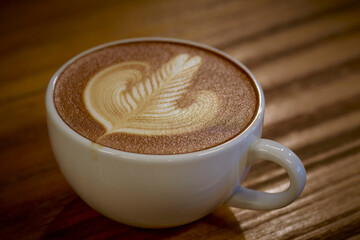 Cup of hot coffee with milk art