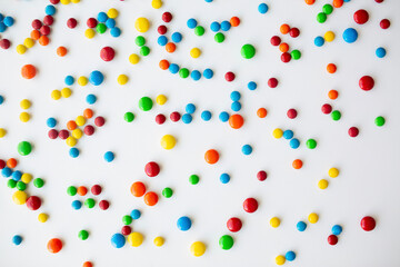 cheerful flat lay white backdrop scene surrounded by rainbow candies