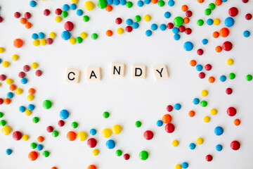 cheerful flat lay white backdrop scene surrounded by rainbow candies