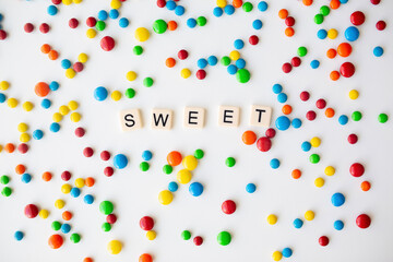 cheerful flat lay white backdrop scene surrounded by rainbow candies