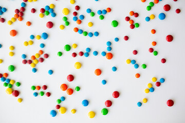 cheerful flat lay white backdrop scene surrounded by rainbow candies