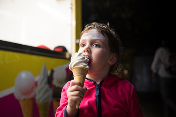 child eating cream in the street