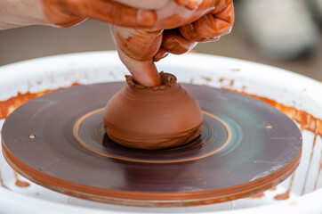 A man using a potter's wheel in pottery