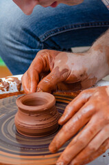 Close-up shot of male potters hands making a bowl