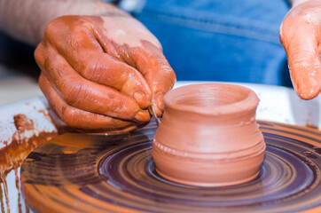 A man using a potter's wheel in pottery