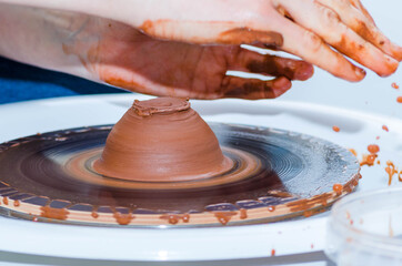 A man using a potter's wheel in pottery