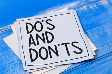 Do's and Don't, words quotes text typography witten on paper against wooden background, list of do...