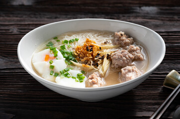 Thai style clear soup rice noodle in traditional bowl. Selective focus