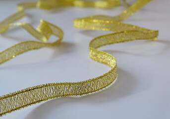 Thin gold ribon on white background
