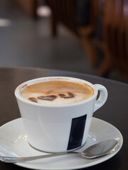 A cup of hot coffee cappuccino, latte decorated with heart art I love you message