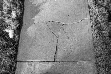 Frost heave crack in residential concrete sidewalk